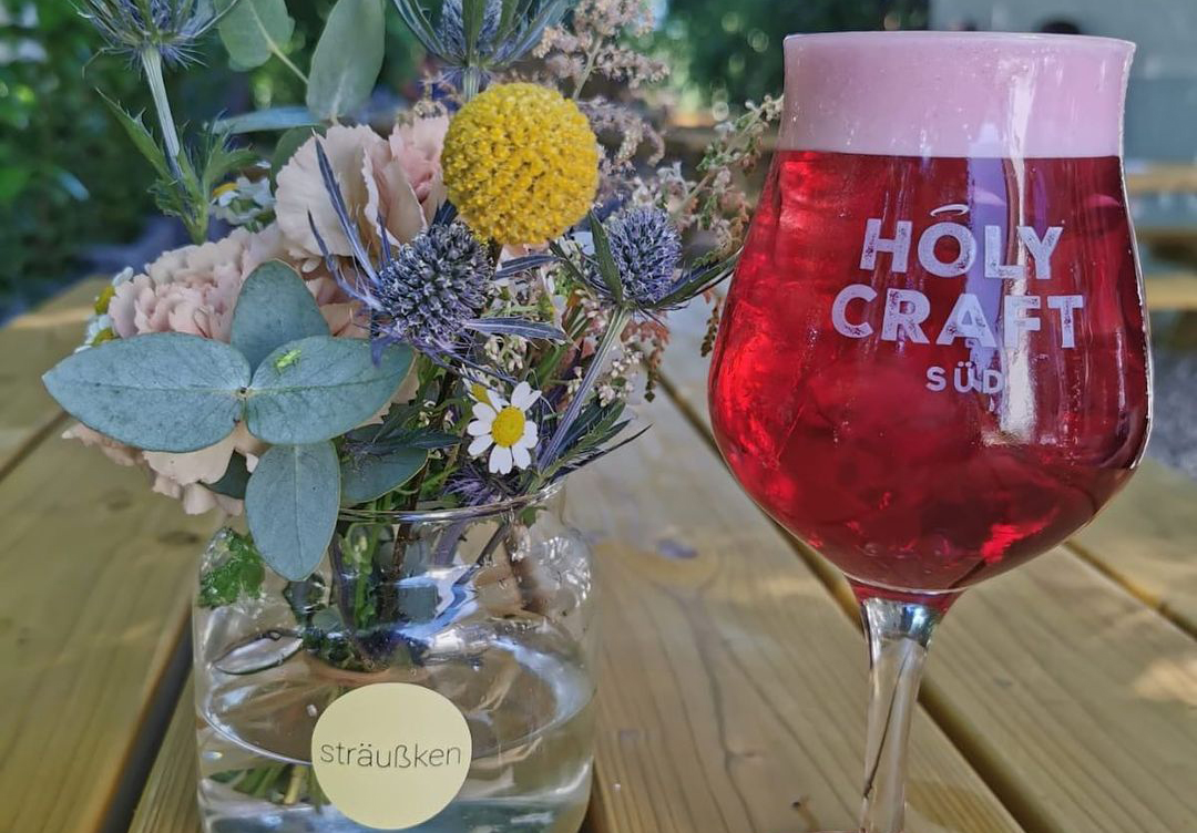 Holy Craft beer glass with flowers in beer garden